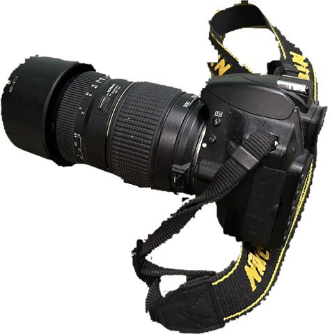A Nikon DSLR with a long Tamron zoom lens and its strap